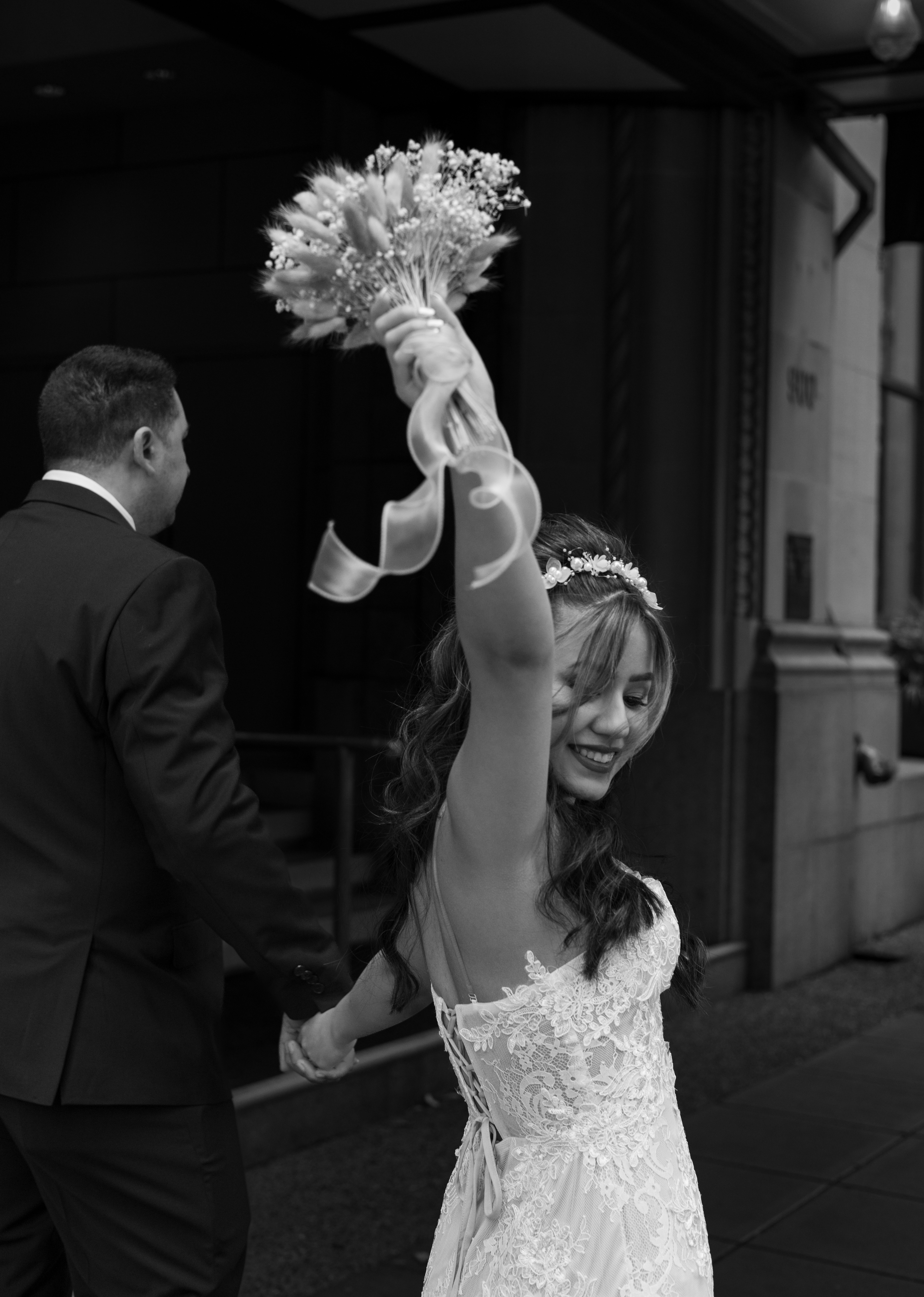 portrait of a bride cheering with her bouquet