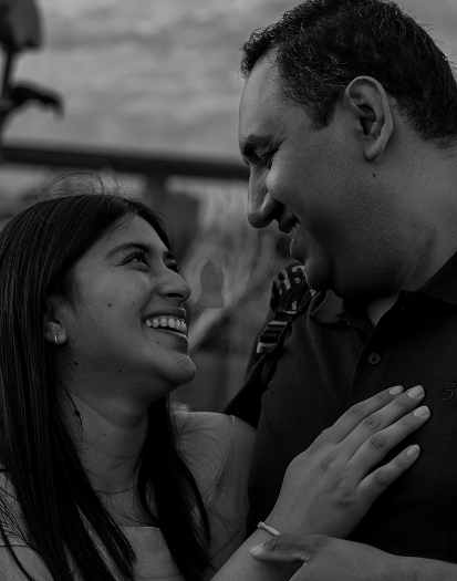 portrait of a couple looking at each other smiling